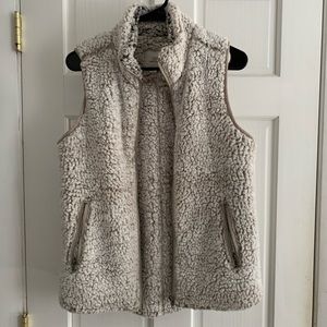 Furry vest with silver zippers